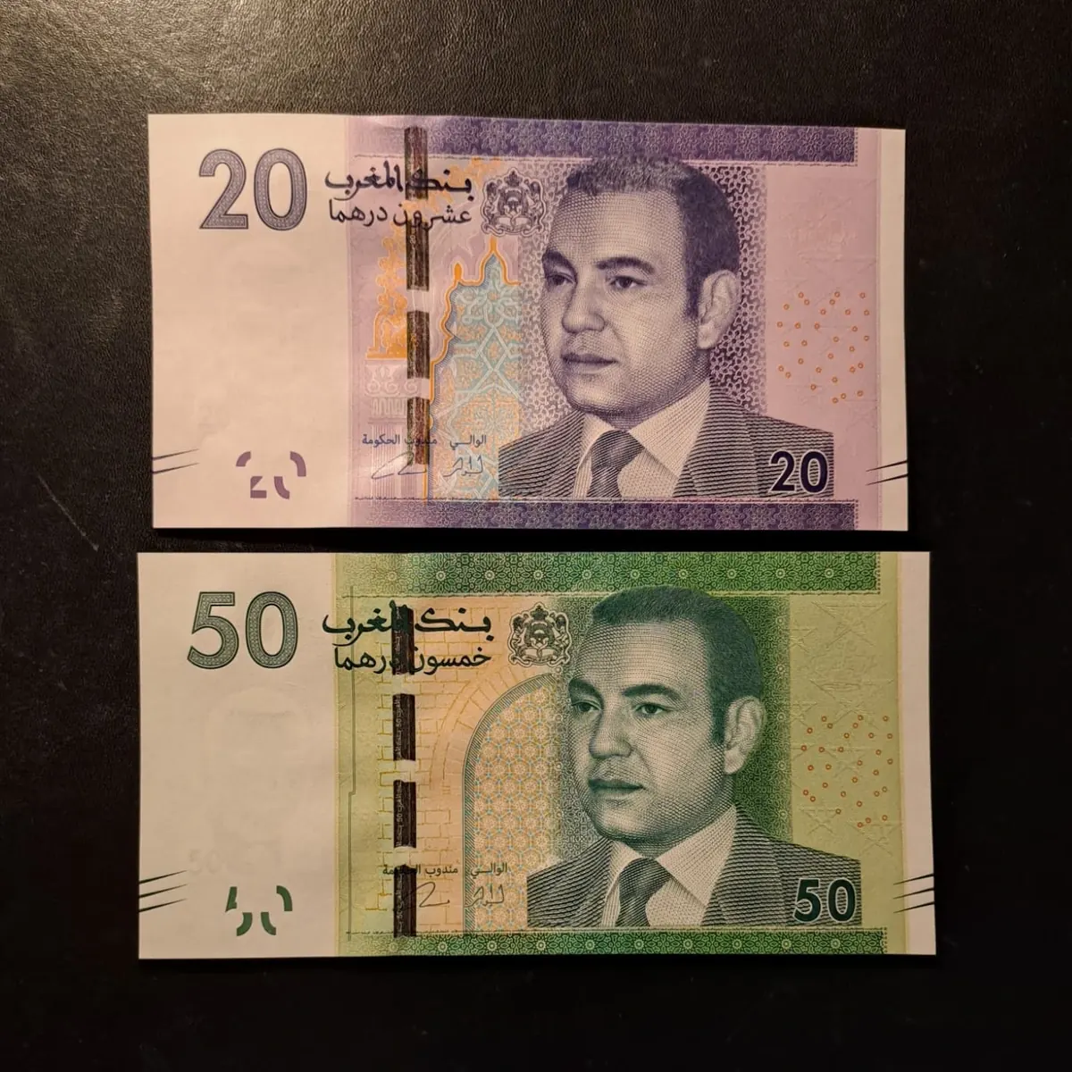 Moroccan 20 and 50 dirham notes from the 2012 series on a black background