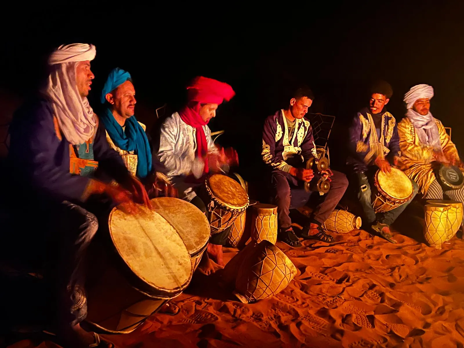 Berber musicians playing drums at night in a Sahara desert camp in Morocco