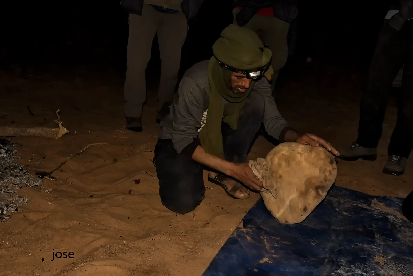 Berber bread baked under the sand, brushed clean at night in a desert camp