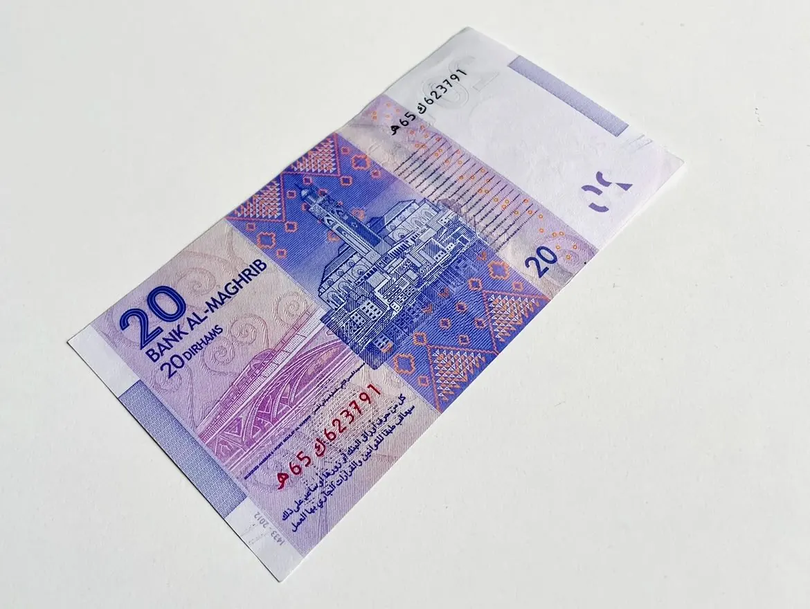 Verso violet d'un billet de 20 dirhams de la série 2012 sur une table blanche